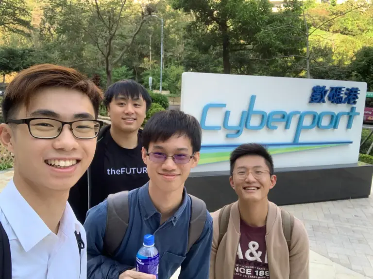 Four young tech enthusiasts posing at Hong Kong's iconic Cyberport (數碼港)